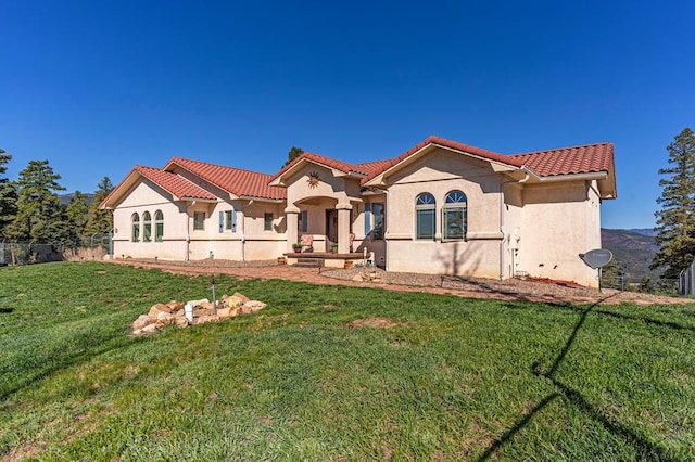 8760 Ridge Rd, Beulah, CO 81023 - mediterranean / spanish house with fence, stucco siding, a tile roof, and a front yard