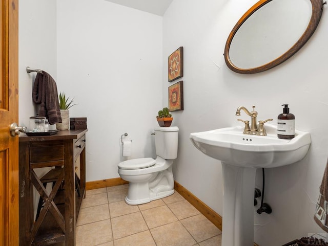 8760 Ridge Rd, Beulah, CO 81023 - bathroom featuring a sink, baseboards, tile patterned flooring, and toilet
