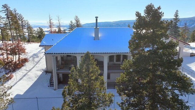 exterior details with metal roof, stairway, fence, and a mountain view