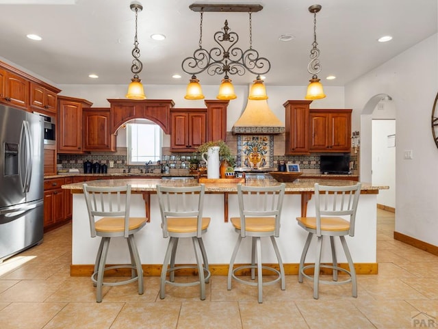 8760 Ridge Rd, Beulah, CO 81023 - kitchen featuring stainless steel fridge, decorative backsplash, pendant lighting, and recessed lighting