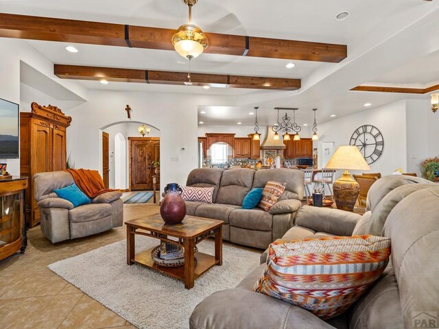 8760 Ridge Rd, Beulah, CO 81023 - living room with light tile patterned floors, arched walkways, recessed lighting, and beam ceiling