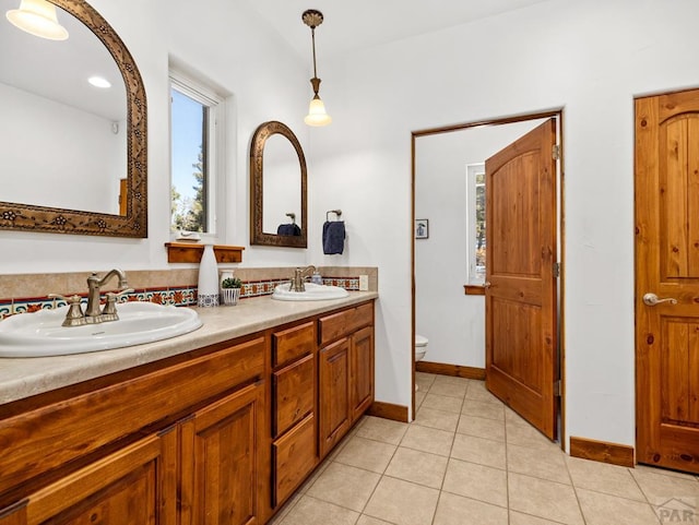 8760 Ridge Rd, Beulah, CO 81023 - bathroom with double vanity, a sink, tile patterned floors, and toilet