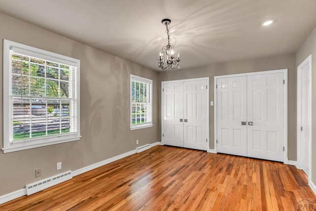 216 Dunsmere Ave, Pueblo, CO 81004 - unfurnished bedroom featuring a chandelier, a baseboard heating unit, baseboards, light wood-style floors, and recessed lighting