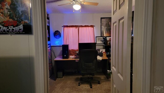 office space featuring carpet, a textured ceiling, and a ceiling fan