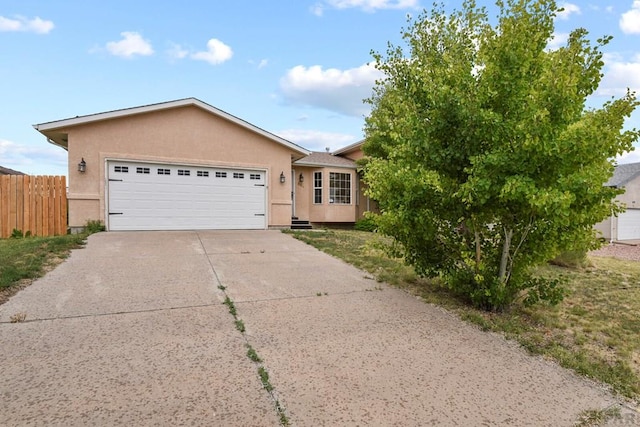 664 S Song Sparrow Dr, Pueblo West, CO 81007 - single story home featuring stucco siding, fence, concrete driveway, and a garage