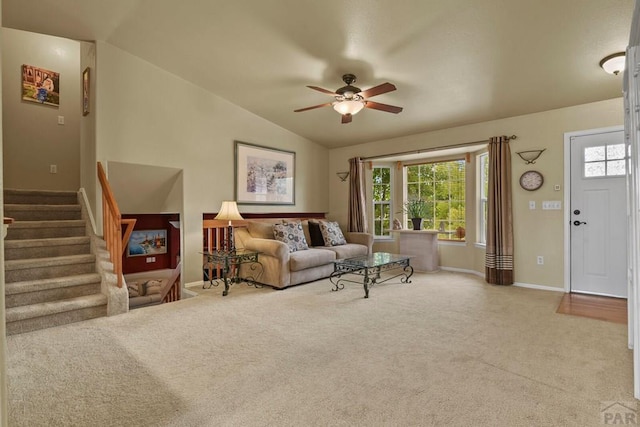 664 S Song Sparrow Dr, Pueblo West, CO 81007 - living area with carpet floors, vaulted ceiling, baseboards, stairway, and a ceiling fan