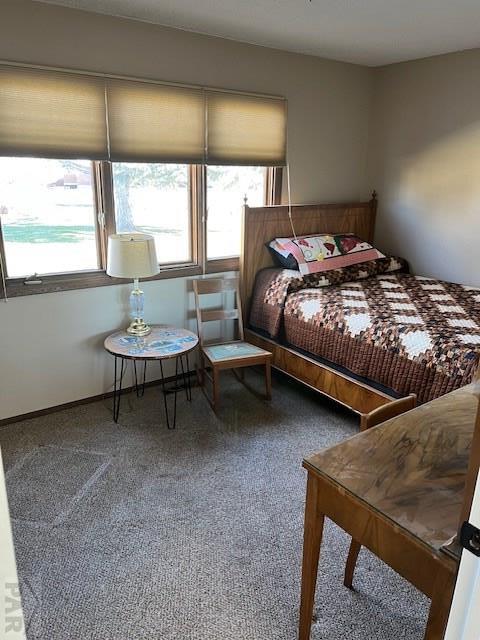 carpeted bedroom featuring baseboards