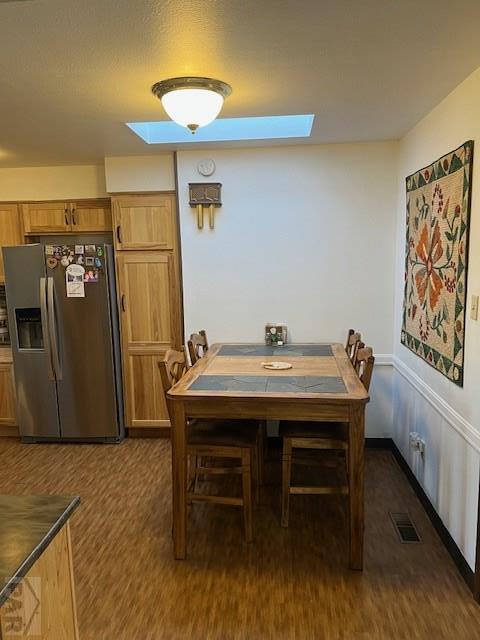 dining space featuring visible vents and dark wood finished floors