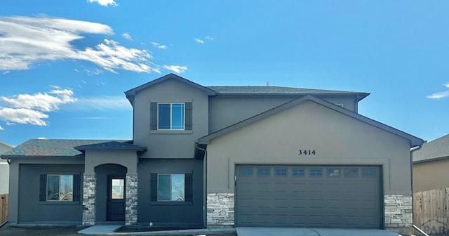 view of front facade featuring a garage, stone siding, and stucco siding