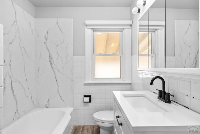 2701 Franklin Ave, Pueblo, CO 81003 - bathroom with toilet, tile walls, wood finished floors, and vanity