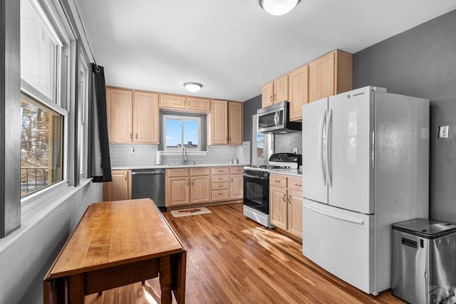 2701 Franklin Ave, Pueblo, CO 81003 - kitchen with appliances with stainless steel finishes, a sink, light wood-style floors, light countertops, and light brown cabinets