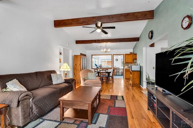 living area featuring lofted ceiling with beams, light wood-style flooring, and ceiling fan with notable chandelier