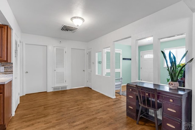 office space with dark wood-type flooring and visible vents