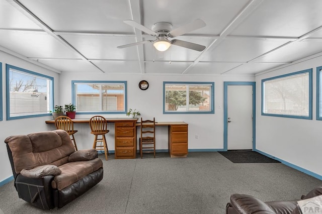 office area with a ceiling fan and baseboards