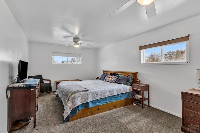 carpeted bedroom featuring ceiling fan and baseboards