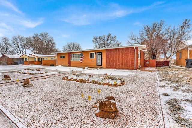 ranch-style home featuring brick siding