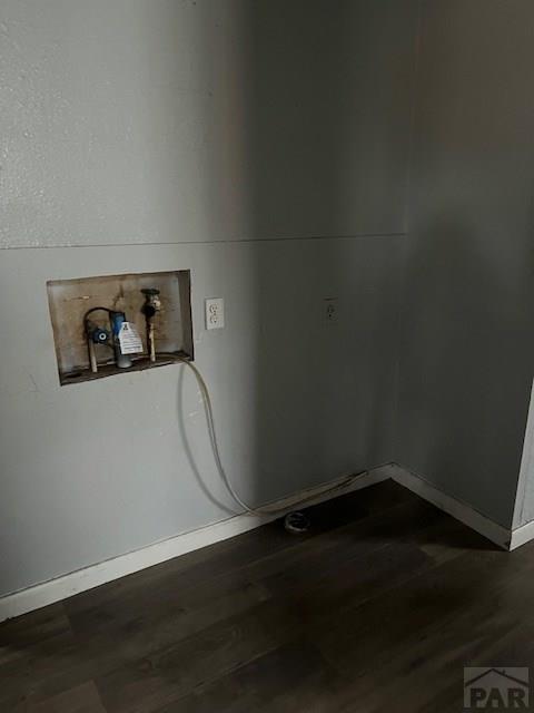 washroom featuring baseboards and dark wood finished floors