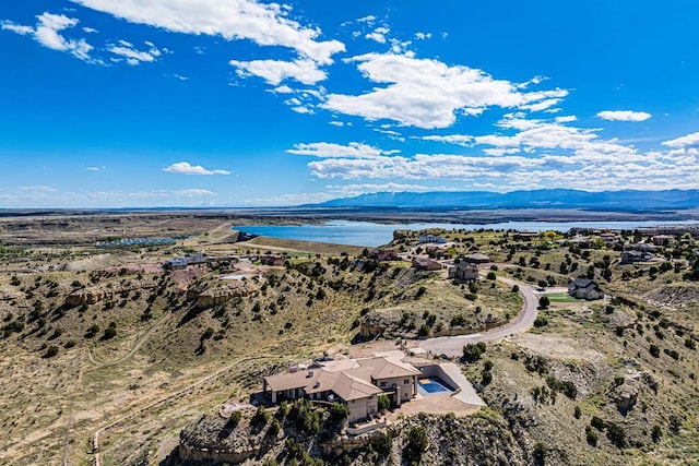 bird's eye view with a water and mountain view