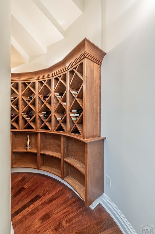 wine room featuring wood finished floors and baseboards