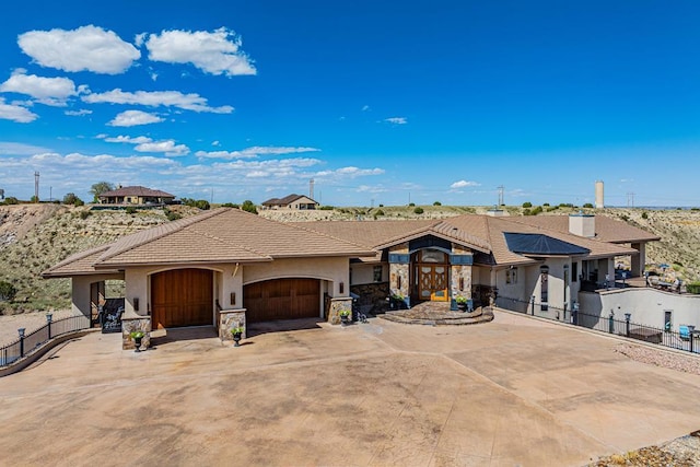 view of front facade with a garage, driveway, and stucco siding