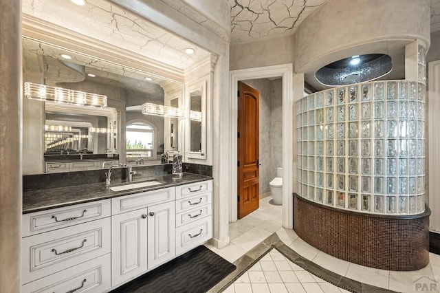 bathroom featuring tile patterned flooring, vanity, and toilet