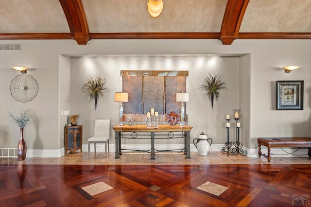 interior space featuring beamed ceiling, visible vents, and baseboards