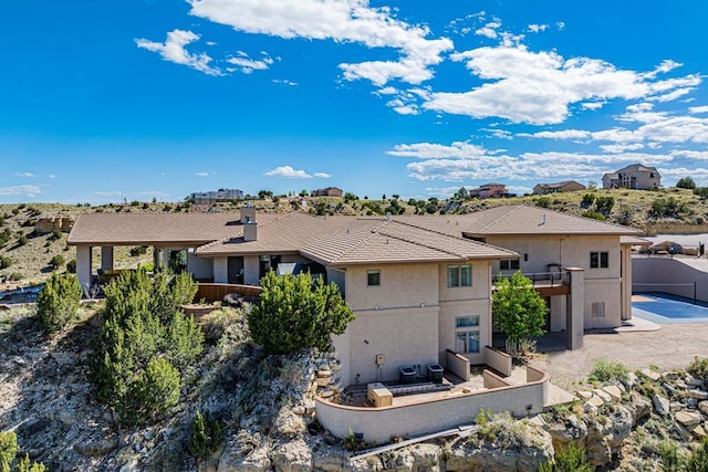 rear view of property featuring a residential view and stucco siding