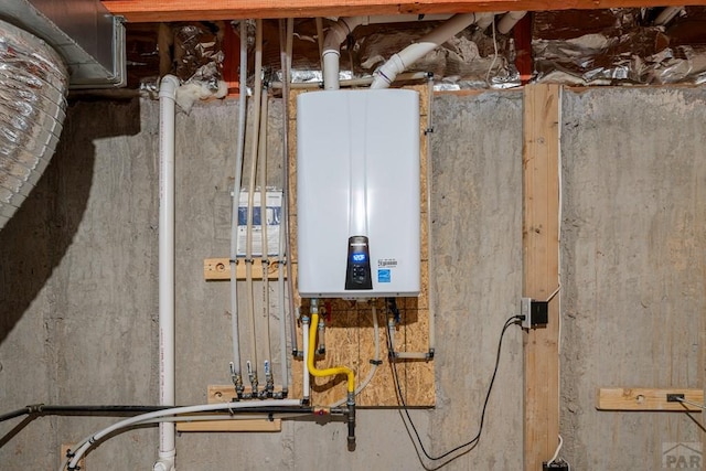 utility room featuring tankless water heater