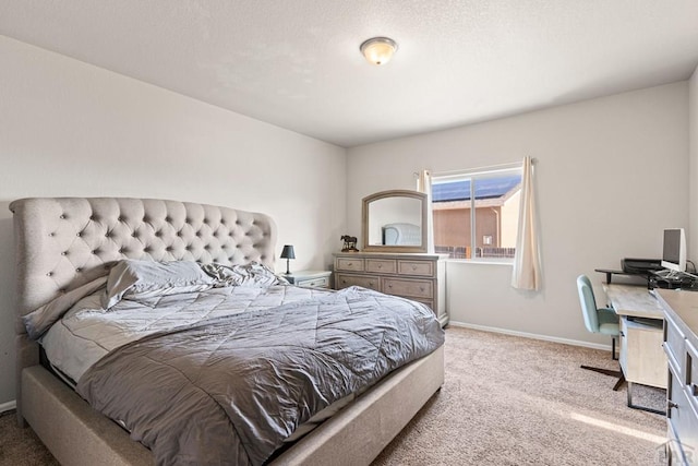 bedroom featuring light colored carpet and baseboards