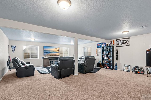 carpeted cinema with baseboards, visible vents, and a textured ceiling