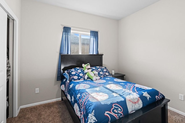 bedroom featuring baseboards and dark colored carpet