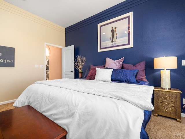 406 N Idledale Dr, Pueblo West, CO 81007 - bedroom with stacked washer / drying machine, carpet floors, and ornamental molding