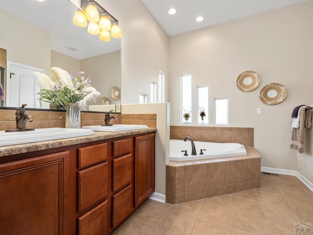 406 N Idledale Dr, Pueblo West, CO 81007 - bathroom featuring double vanity, a bath, tile patterned floors, and recessed lighting