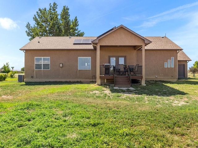 406 N Idledale Dr, Pueblo West, CO 81007 - back of house with a deck, a lawn, solar panels, stucco siding, and french doors