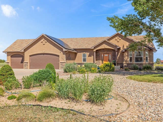 406 N Idledale Dr, Pueblo West, CO 81007 - ranch-style home with a garage, stone siding, driveway, and stucco siding
