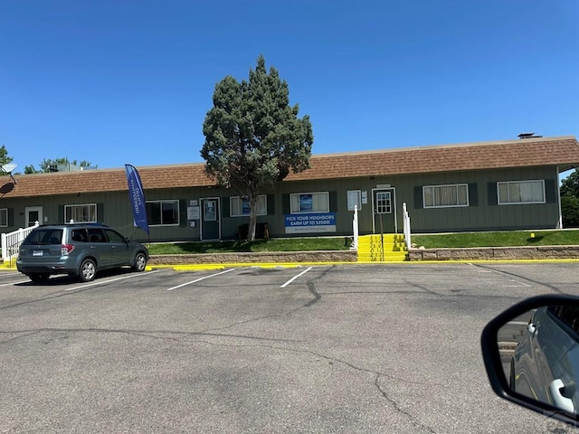 999 Fortino Blvd Unit 20, Pueblo, CO 81008 - view of front facade featuring mansard roof, uncovered parking, and a shingled roof