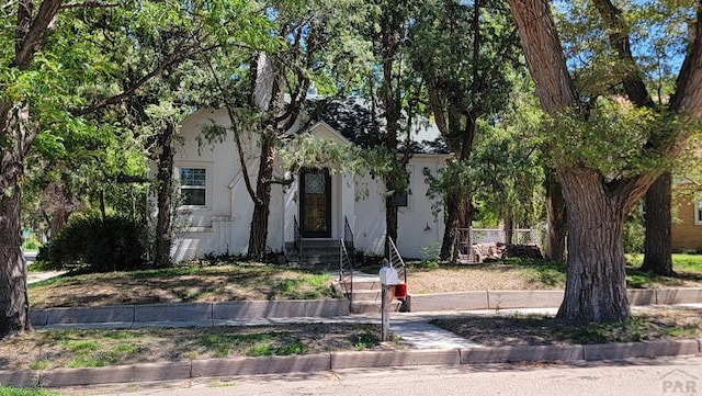 obstructed view of property with stucco siding