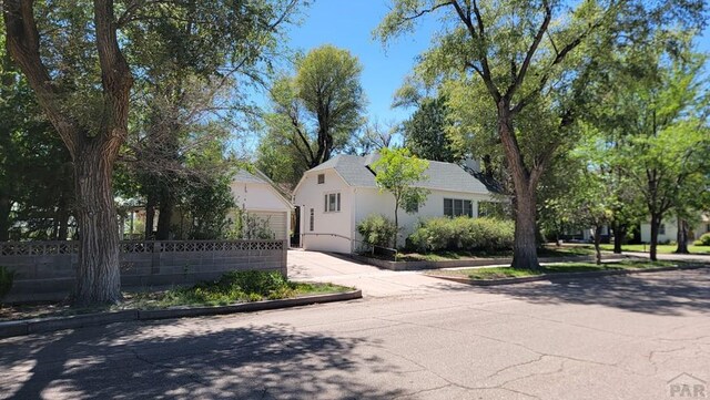 view of front of property featuring fence and stucco siding