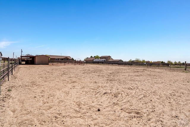 503 N Iliff Dr, Pueblo West, CO 81007 - view of yard with an enclosed horse arena, an exterior structure, an outdoor structure, a rural view, and fence
