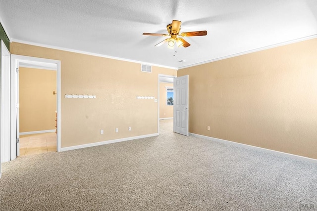 503 N Iliff Dr, Pueblo West, CO 81007 - empty room featuring ornamental molding, a ceiling fan, carpet, baseboards, and a textured ceiling