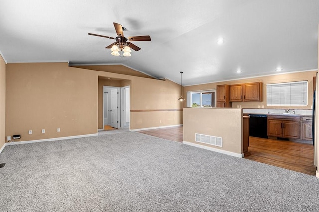 503 N Iliff Dr, Pueblo West, CO 81007 - kitchen with dishwasher, light carpet, a ceiling fan, brown cabinets, and baseboards