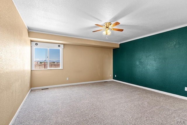 503 N Iliff Dr, Pueblo West, CO 81007 - spare room featuring a textured wall, a ceiling fan, a textured ceiling, carpet floors, and baseboards