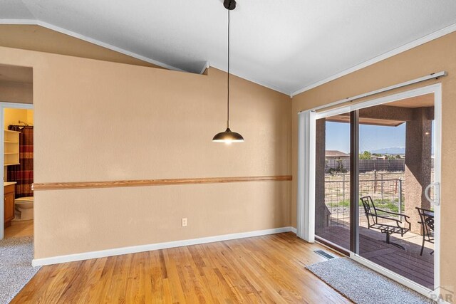 503 N Iliff Dr, Pueblo West, CO 81007 - unfurnished dining area featuring lofted ceiling, light wood-style flooring, baseboards, and ornamental molding