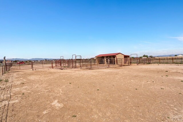 503 N Iliff Dr, Pueblo West, CO 81007 - view of yard with an exterior structure, an outbuilding, a view of rural / pastoral area, and a mountain view