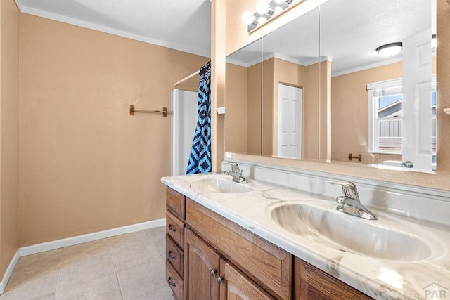 503 N Iliff Dr, Pueblo West, CO 81007 - full bath featuring baseboards, double vanity, tile patterned flooring, crown molding, and a textured ceiling