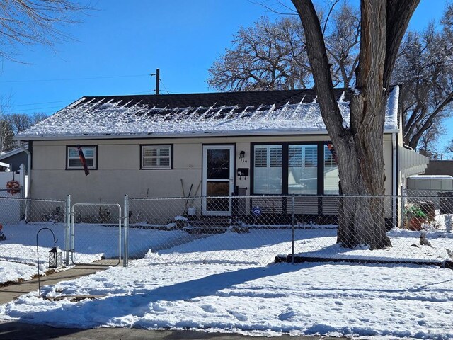 view of front of property with fence and stucco siding