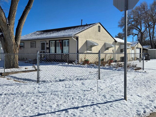 exterior space featuring a fenced front yard and stucco siding