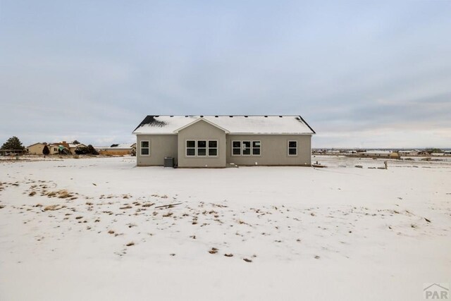 snow covered property featuring cooling unit