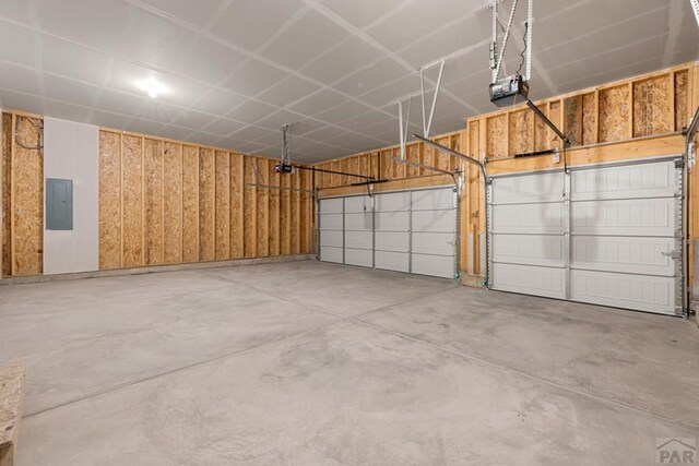 garage with electric panel and a garage door opener