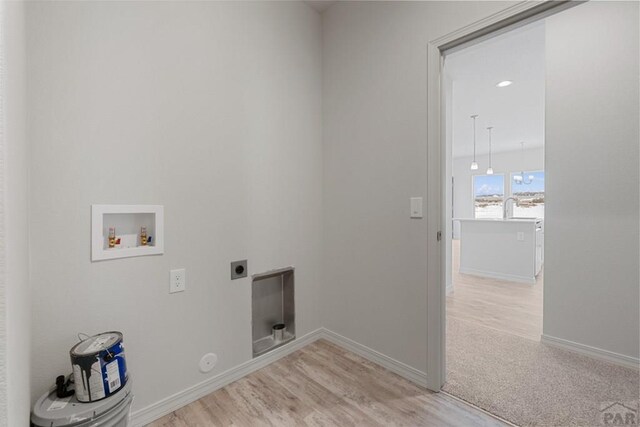 laundry room with laundry area, washer hookup, baseboards, light wood-type flooring, and electric dryer hookup